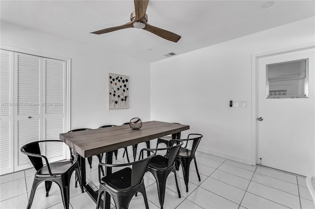 tiled dining area with ceiling fan