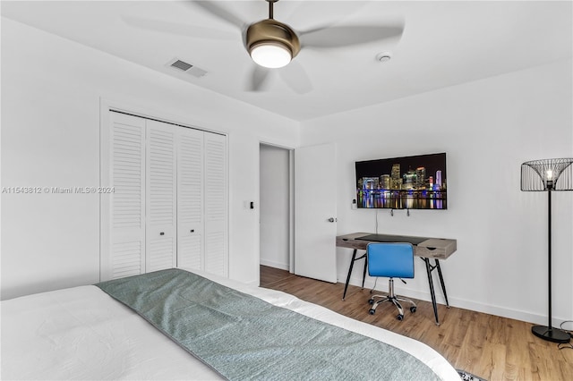 bedroom with a closet, ceiling fan, and hardwood / wood-style flooring