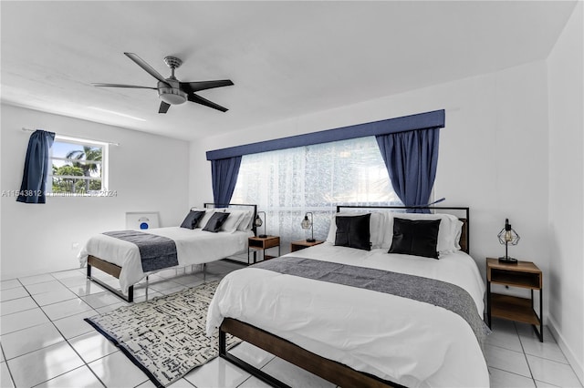 tiled bedroom featuring ceiling fan