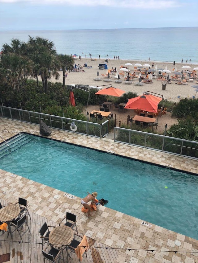 view of swimming pool with a water view