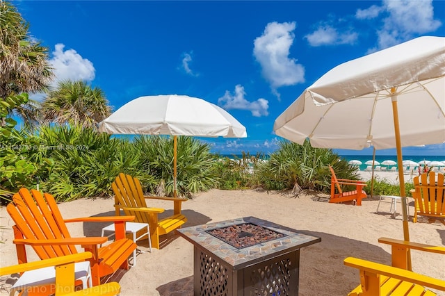 view of patio featuring a fire pit and a water view