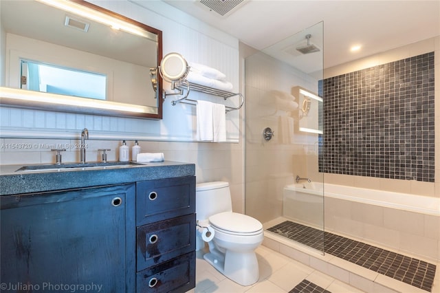 bathroom featuring vanity, tile walls, a shower with door, tile flooring, and toilet