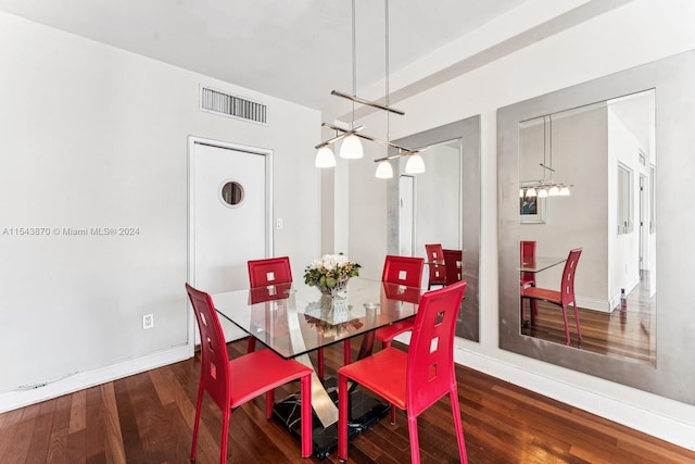 dining area featuring a chandelier and dark wood-type flooring