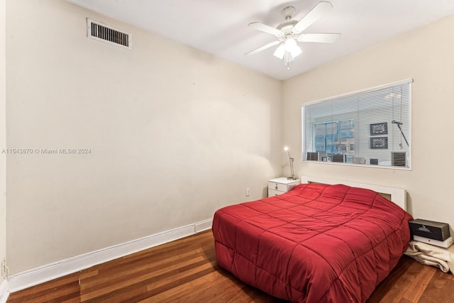 bedroom featuring ceiling fan and dark hardwood / wood-style flooring