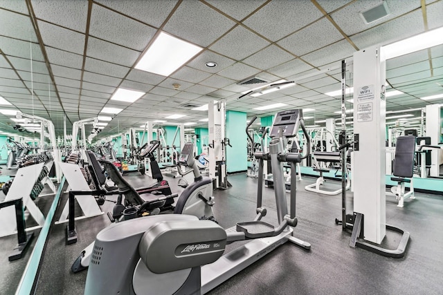 gym with a paneled ceiling