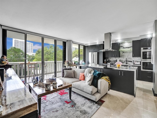 tiled living room featuring expansive windows and sink