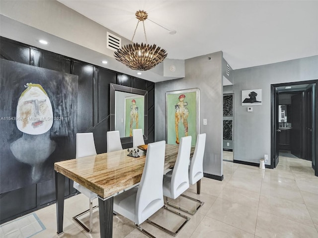 tiled dining area featuring a notable chandelier