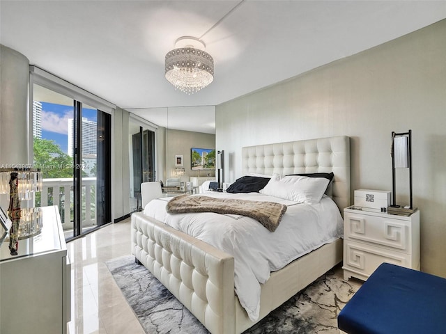 tiled bedroom featuring an inviting chandelier, expansive windows, multiple windows, and access to exterior