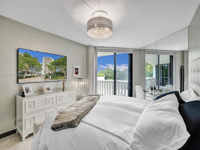 bedroom with an inviting chandelier, light tile flooring, a wall of windows, and access to exterior