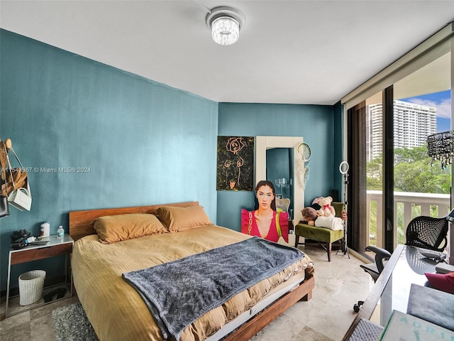 bedroom with light tile floors and expansive windows