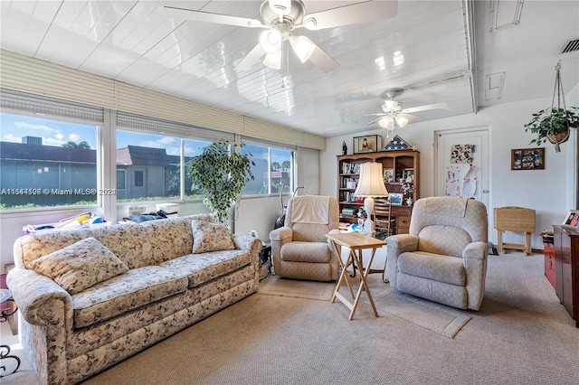 carpeted living room with ceiling fan