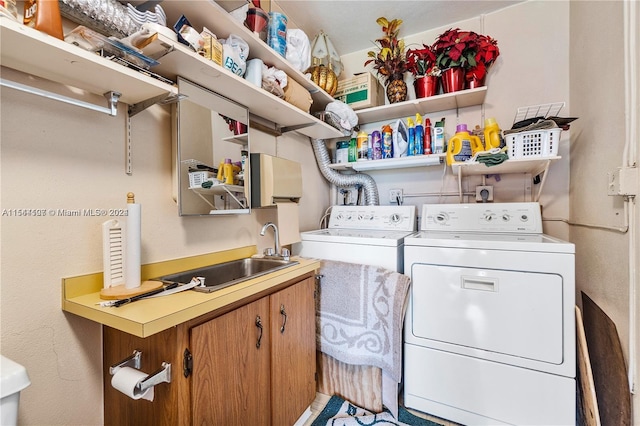 laundry area featuring electric dryer hookup, washer and dryer, and sink