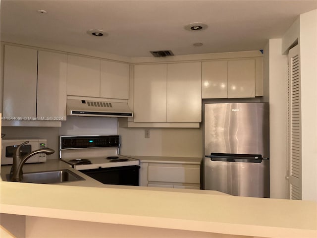 kitchen featuring white cabinets, white appliances, and sink