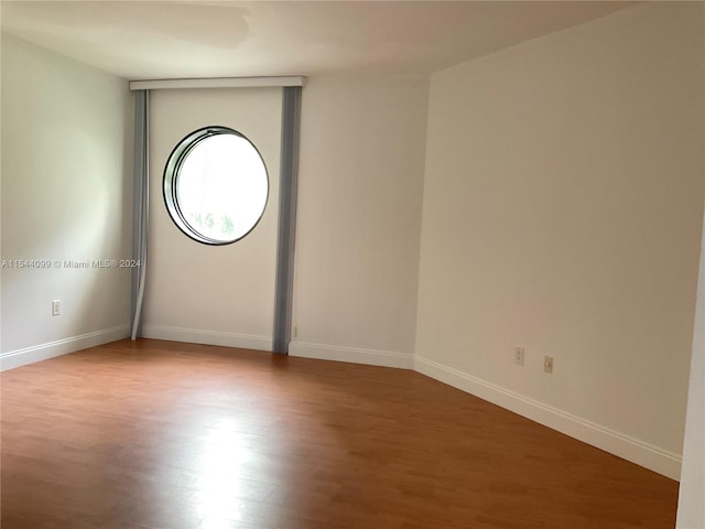 empty room with light hardwood / wood-style flooring