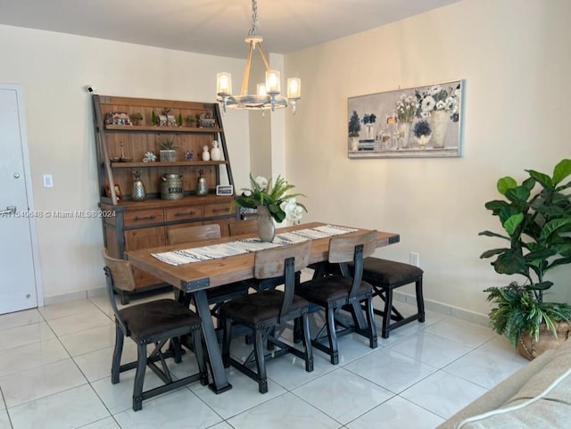 tiled dining area featuring a notable chandelier