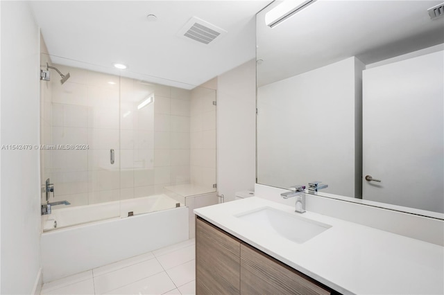 bathroom with vanity, combined bath / shower with glass door, and tile patterned flooring