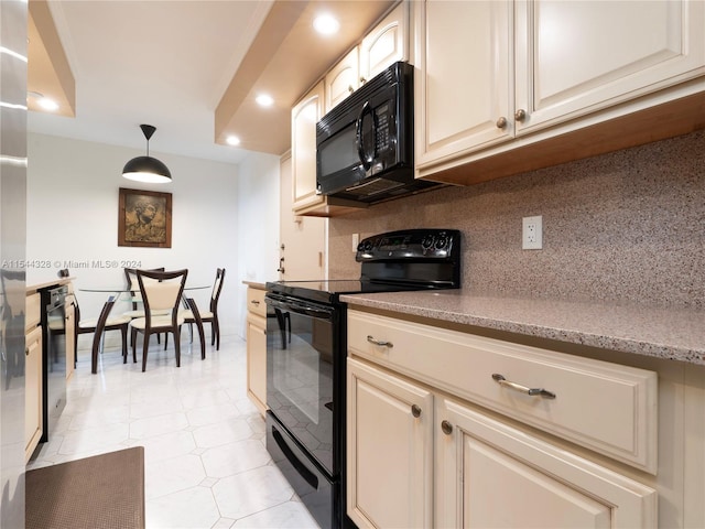 kitchen featuring decorative backsplash, black appliances, cream cabinets, light tile patterned floors, and decorative light fixtures