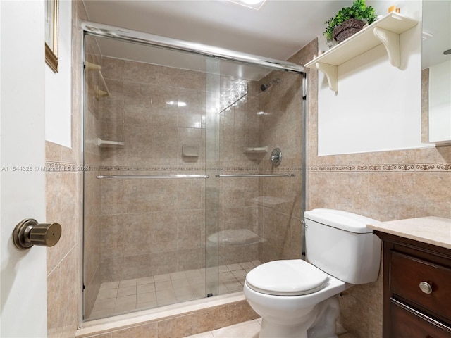 bathroom featuring walk in shower, vanity, tile walls, and toilet