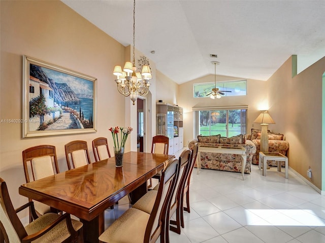 dining room with ceiling fan with notable chandelier, lofted ceiling, and light tile patterned flooring