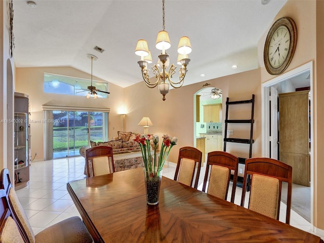 dining space with vaulted ceiling, light tile patterned floors, and ceiling fan with notable chandelier