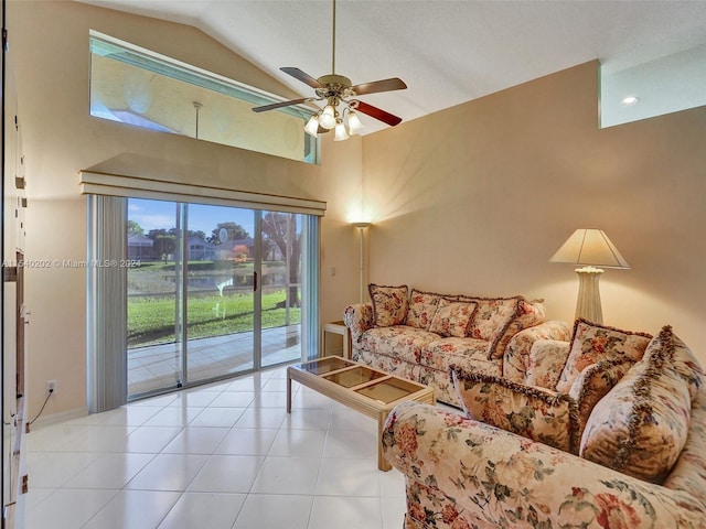 living room with ceiling fan, light tile patterned flooring, and vaulted ceiling