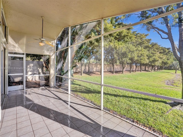 unfurnished sunroom with ceiling fan