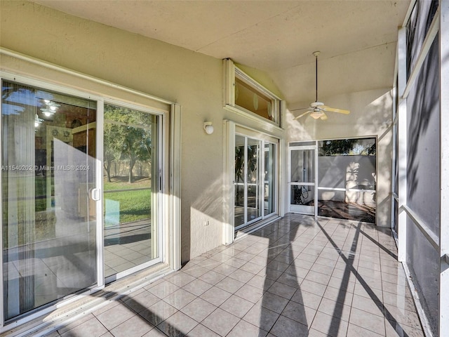 unfurnished sunroom featuring ceiling fan and lofted ceiling