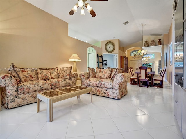 living room with tile patterned flooring, ceiling fan with notable chandelier, and lofted ceiling