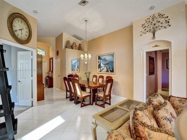 tiled dining area featuring a chandelier