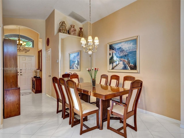 tiled dining space with high vaulted ceiling and an inviting chandelier