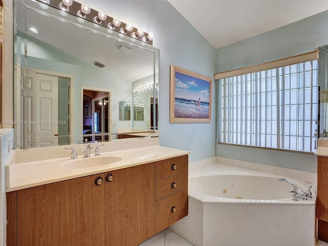 bathroom featuring vanity, lofted ceiling, and a tub