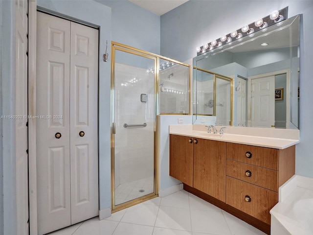 bathroom featuring tile patterned floors, vanity, and an enclosed shower