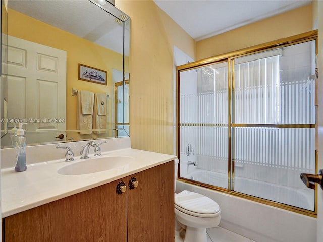 full bathroom with tile patterned flooring, vanity, toilet, and enclosed tub / shower combo