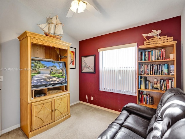 carpeted living room featuring vaulted ceiling and ceiling fan