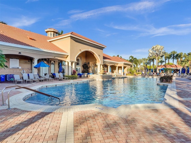 view of pool with a patio area and ceiling fan