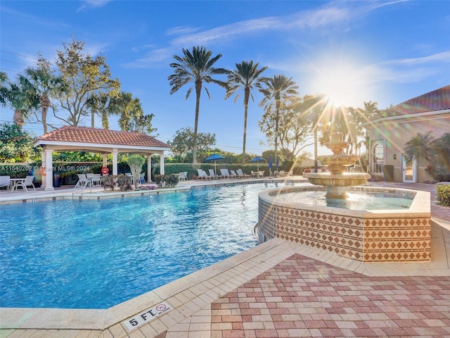 view of pool with a gazebo and pool water feature