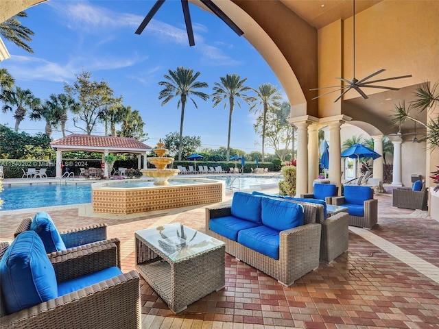 view of patio / terrace with outdoor lounge area, a gazebo, pool water feature, and a community pool