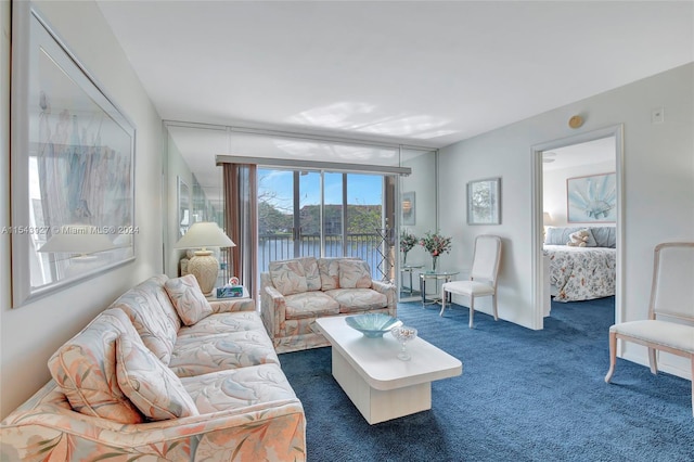 living room featuring a water view and dark carpet