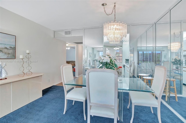 carpeted dining space with an inviting chandelier