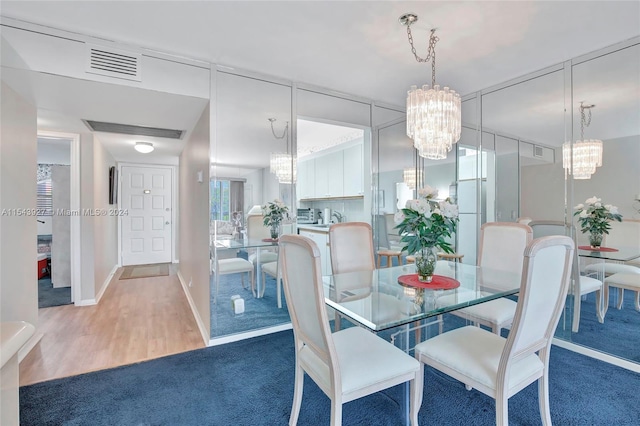 dining space featuring a chandelier and dark wood-type flooring