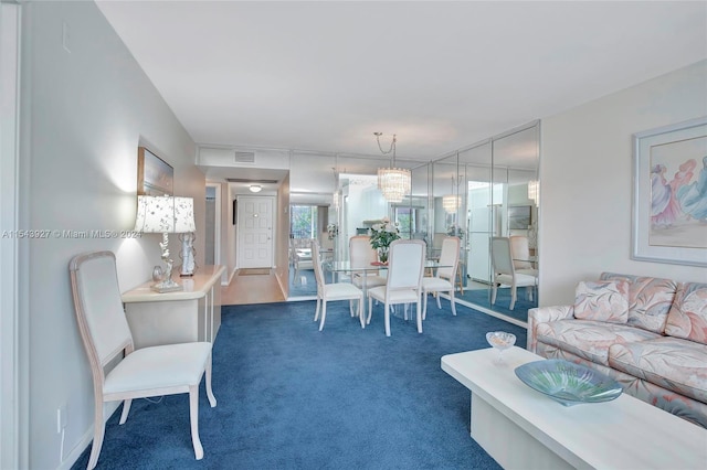 carpeted living room featuring an inviting chandelier