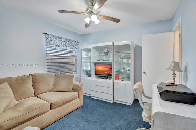 living room with ceiling fan and dark carpet