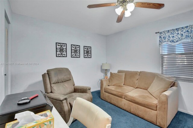 carpeted living room with ceiling fan