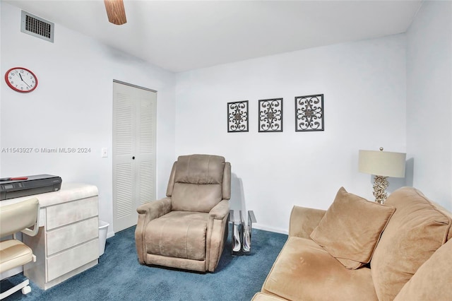 living area featuring ceiling fan and dark carpet