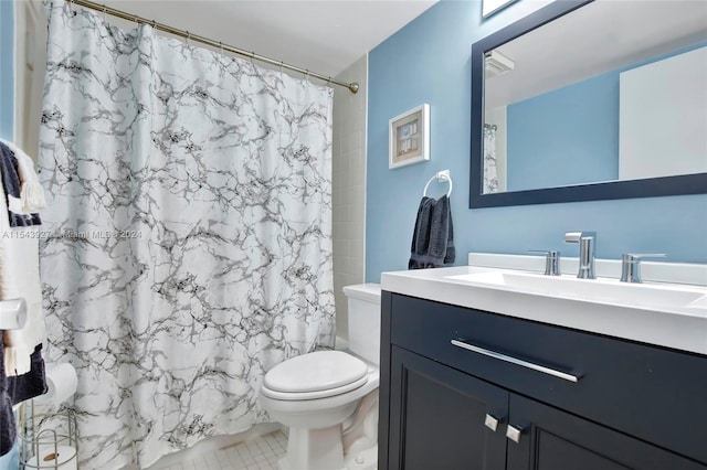 bathroom featuring vanity, tile floors, and toilet