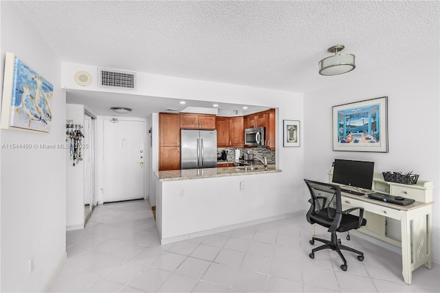 office with sink and a textured ceiling