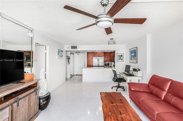 345 Ocean Dr Unit 411, Miami Beach, FL 33139 - living room with a desk, a textured ceiling, ceiling fan, and light tile patterned floors