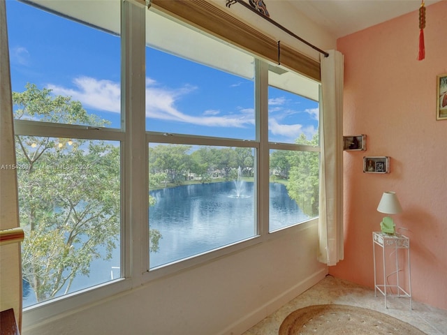 unfurnished sunroom with a water view and a wealth of natural light