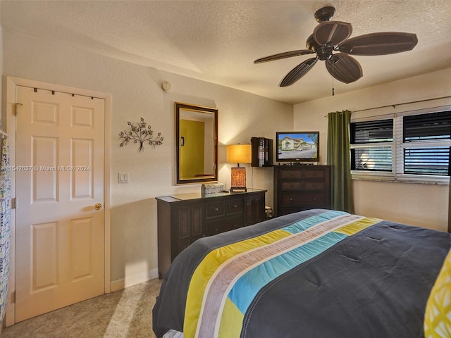 bedroom with light carpet, a textured ceiling, and ceiling fan