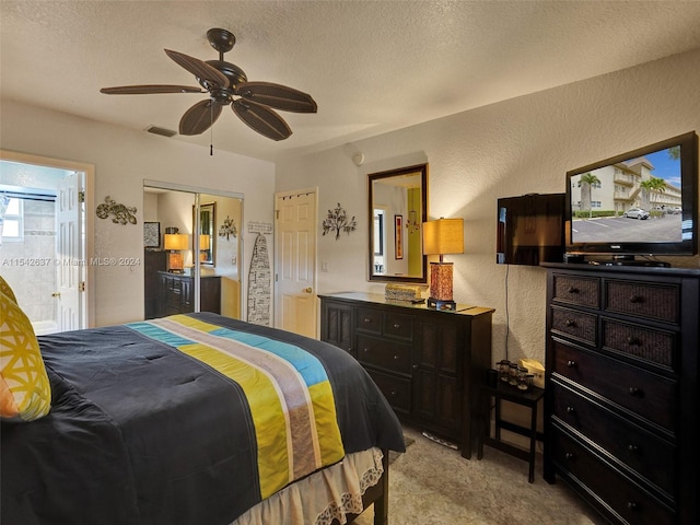 bedroom with ceiling fan and a textured ceiling